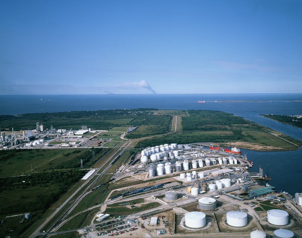 Aerial photograph of an oil refinery with tanks, process areas and connecting roads.
